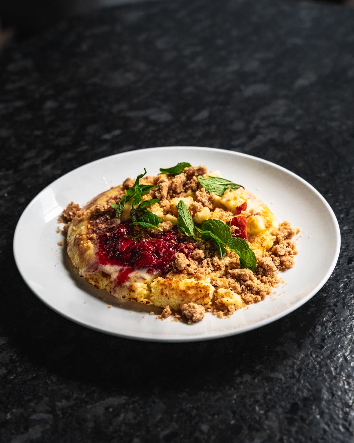 Spiced mince over a smooth base with pickled onion and fresh herbs